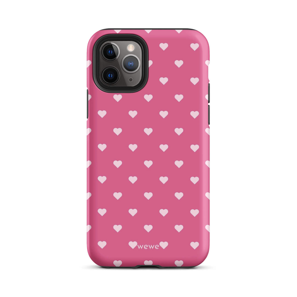 Bubblegum-pink iPhone case with evenly spaced pale blush-pink mini hearts