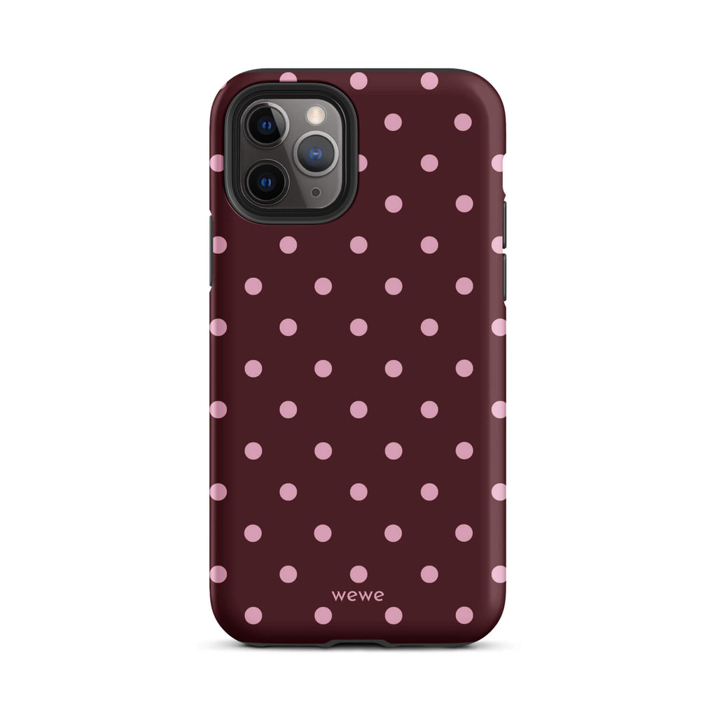 Deep burgundy iPhone case with evenly spaced soft-pink polka dots
