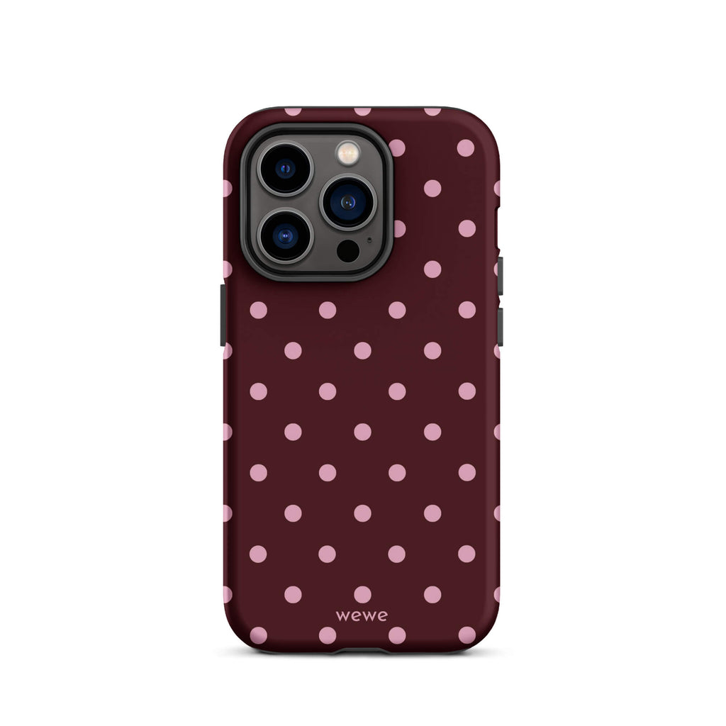 Deep burgundy iPhone case with evenly spaced soft-pink polka dots
