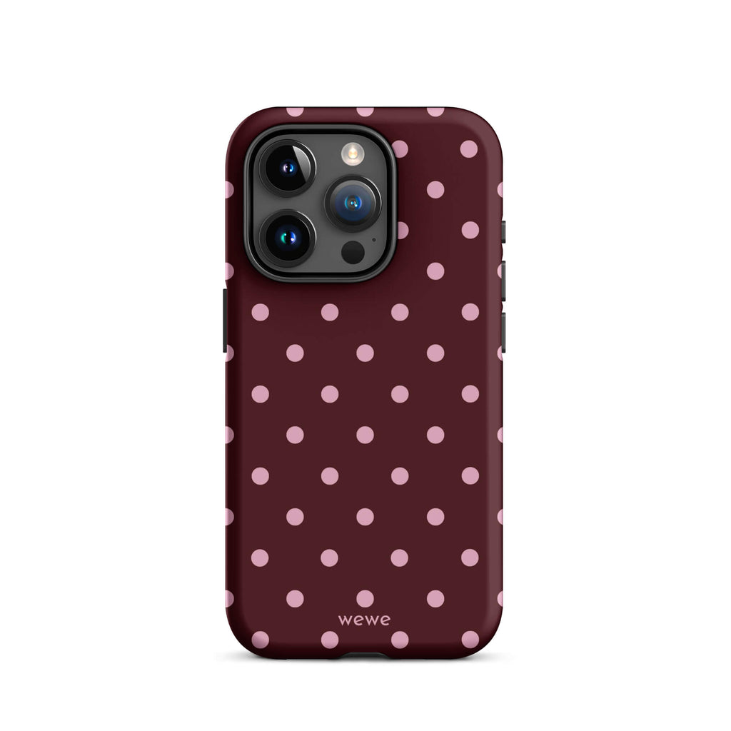 Deep burgundy iPhone case with evenly spaced soft-pink polka dots