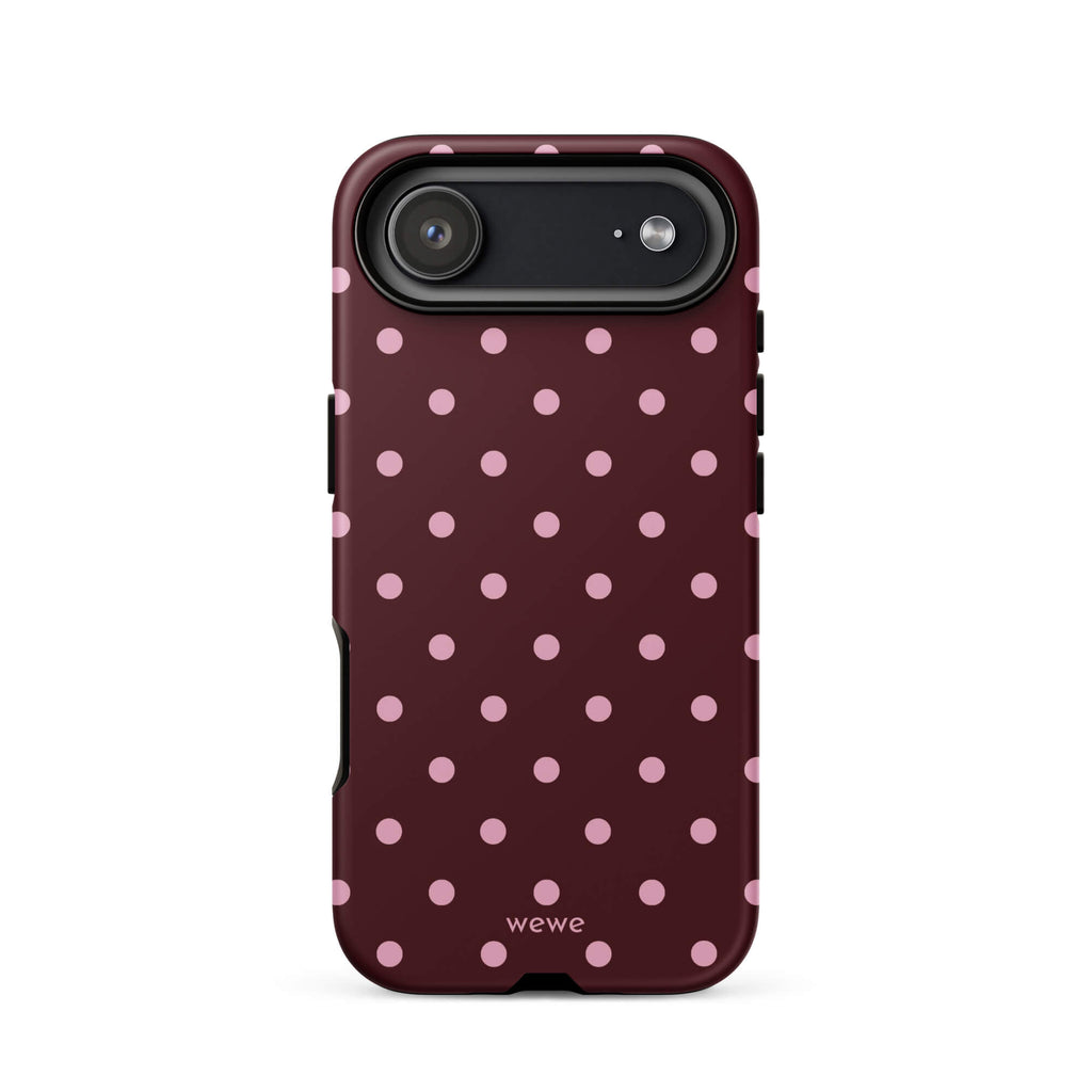 Deep burgundy iPhone case with evenly spaced soft-pink polka dots