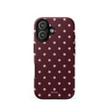 Deep burgundy iPhone case with evenly spaced soft-pink polka dots