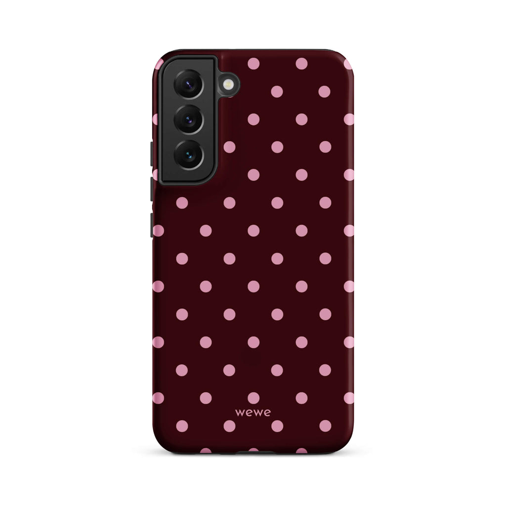 Deep burgundy iPhone case with evenly spaced soft-pink polka dots