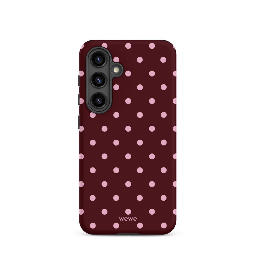 Deep burgundy iPhone case with evenly spaced soft-pink polka dots