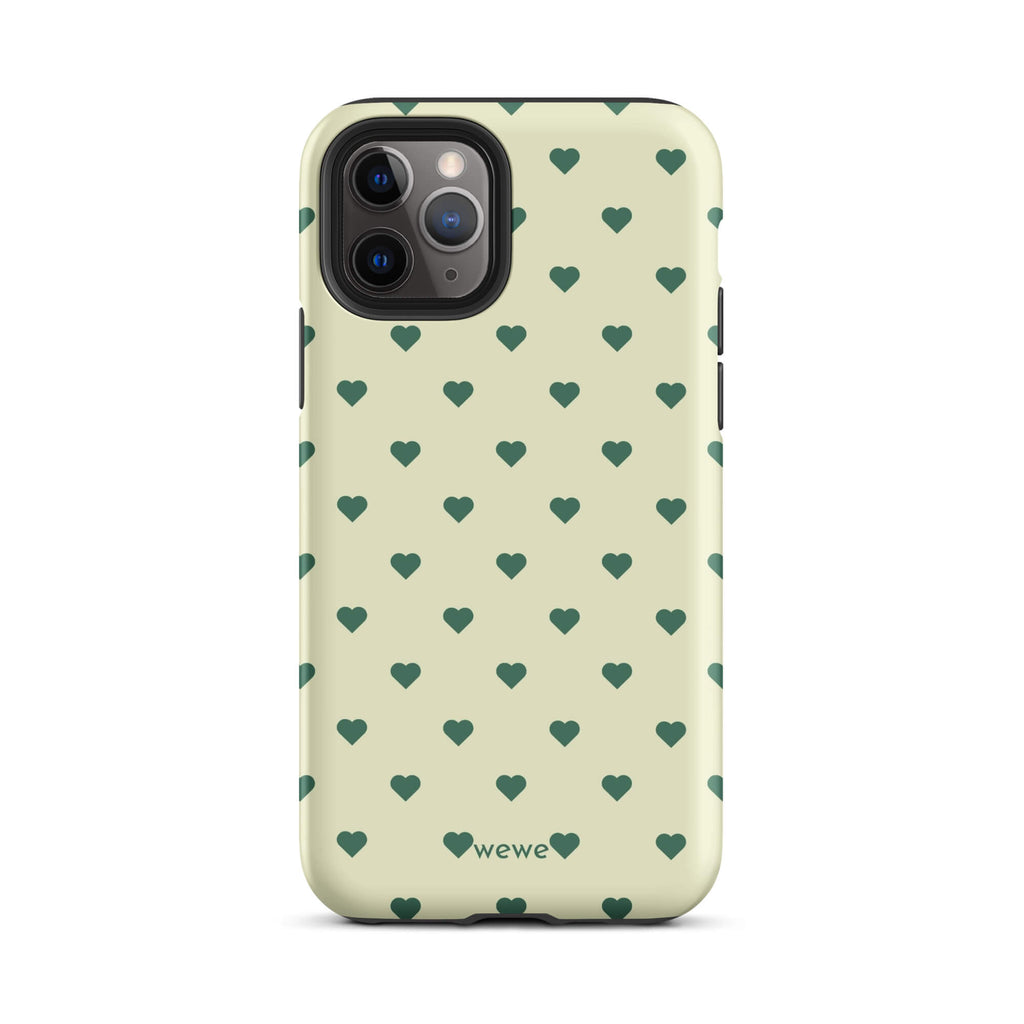 Pale buttercream iPhone case with evenly spaced forest-green mini hearts