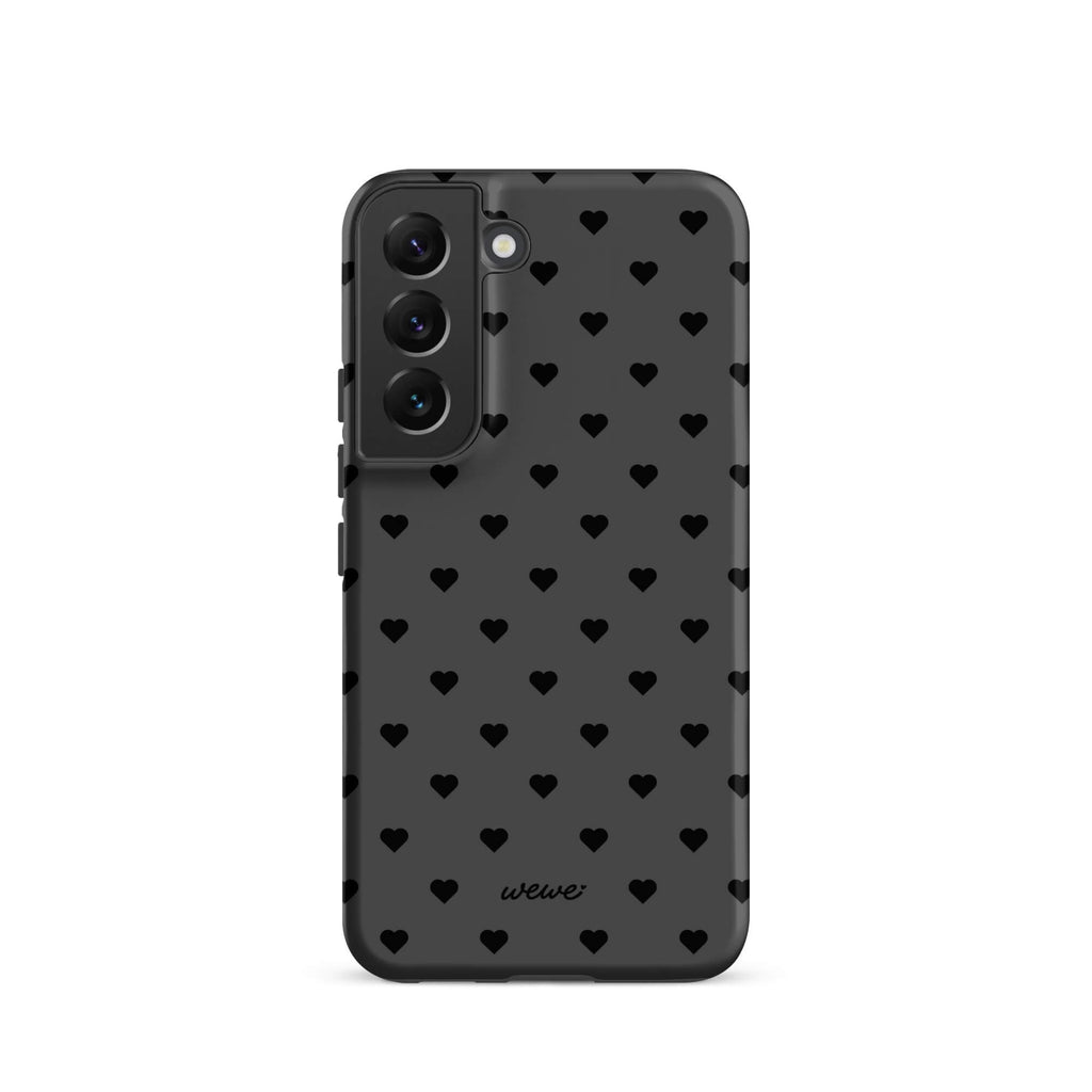 Charcoal-gray iPhone case with evenly spaced black mini hearts