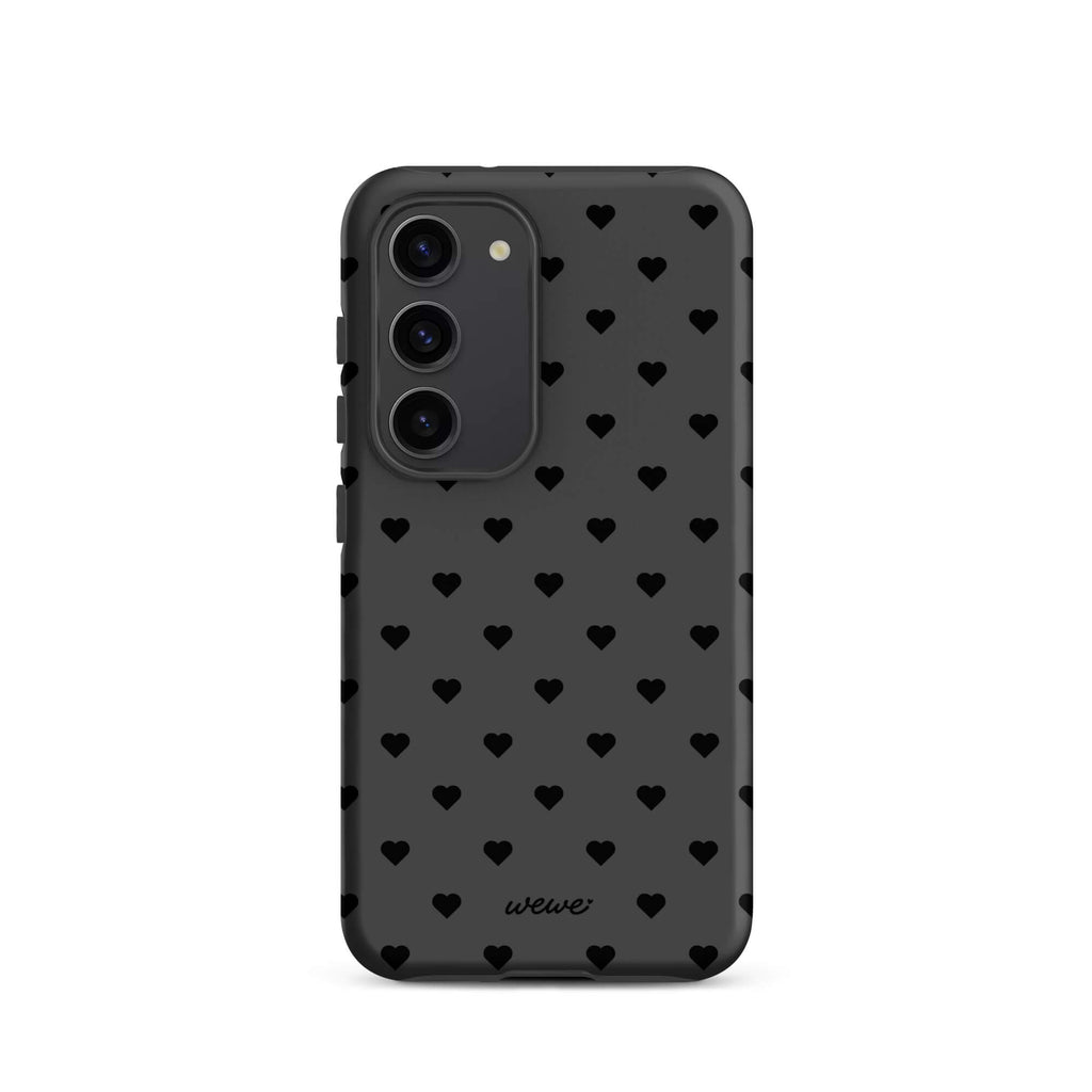 Charcoal-gray iPhone case with evenly spaced black mini hearts