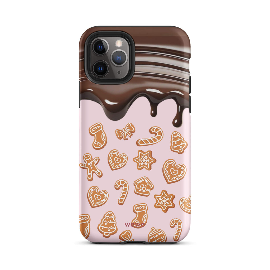 Custom iPhone 11 pro tough case featuring a top section resembling a melted chocolate bar dripping down onto a light pink background that is covered in a festive pattern of classic gingerbread cookies (gingerbread men, hearts, stars, candy canes, and trees), with 'wewe' branding at the bottom.