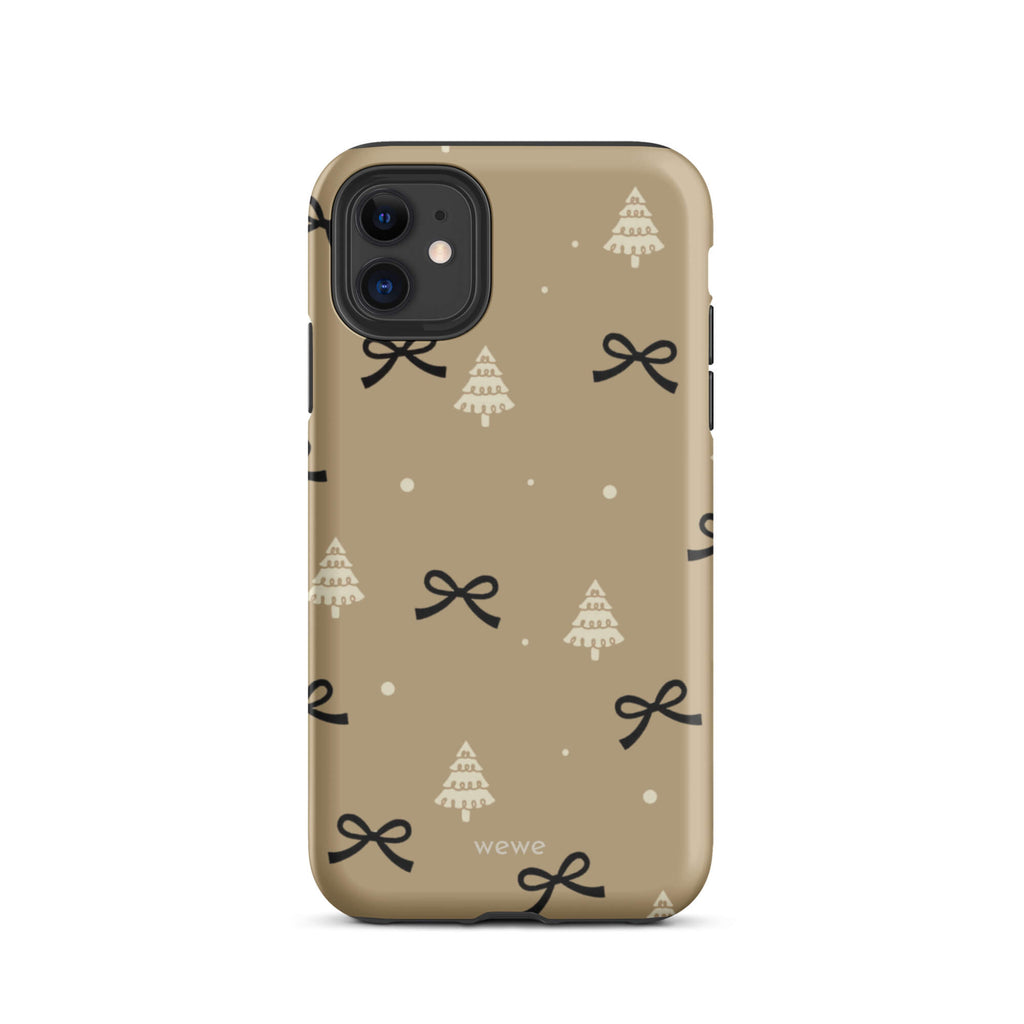 Custom iPhone 11 tough case in matte taupe/khaki brown featuring a scattered holiday pattern of small black bows, white doodle Christmas trees, and white snowflakes/dots, with 'wewe' branding at the bottom.