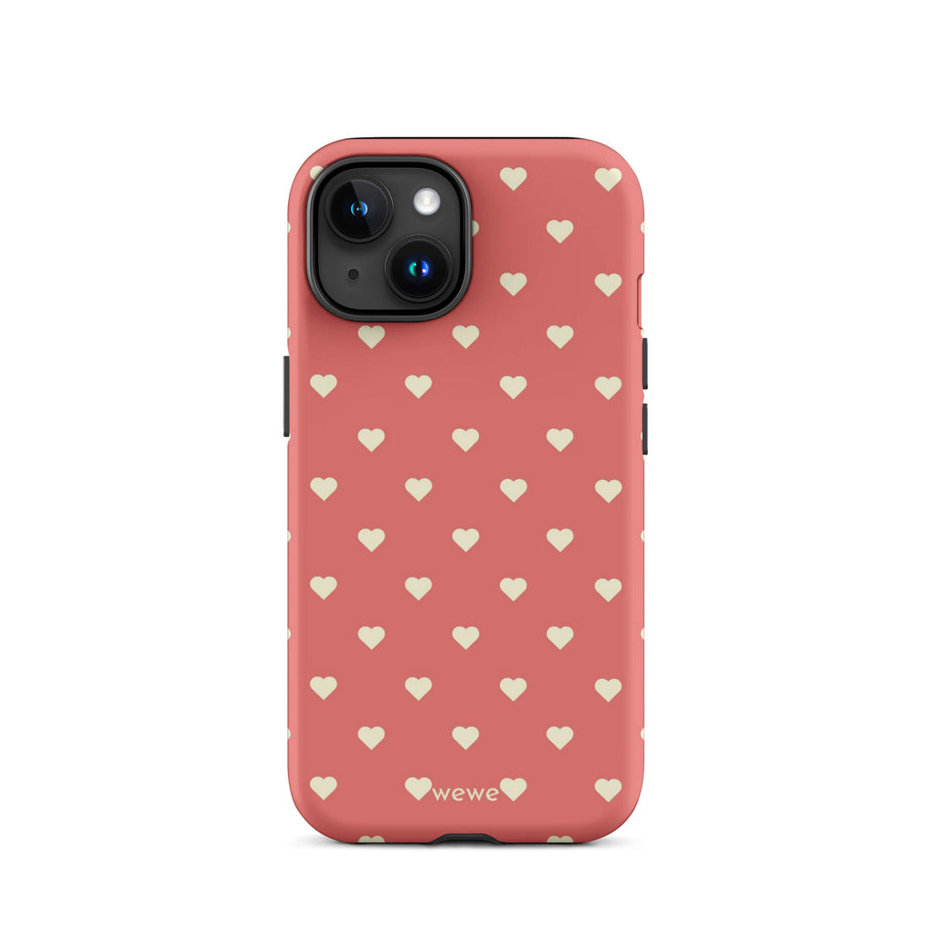 Coral-pink iPhone case with evenly spaced soft-cream mini hearts