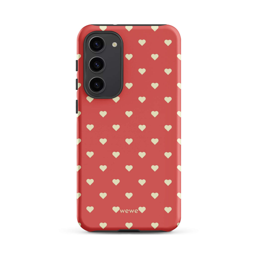Coral-pink iPhone case with evenly spaced soft-cream mini hearts