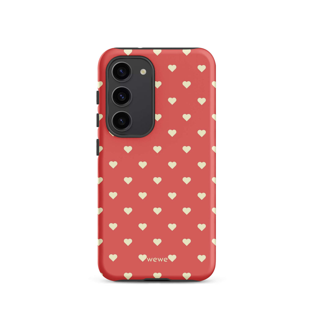 Coral-pink iPhone case with evenly spaced soft-cream mini hearts