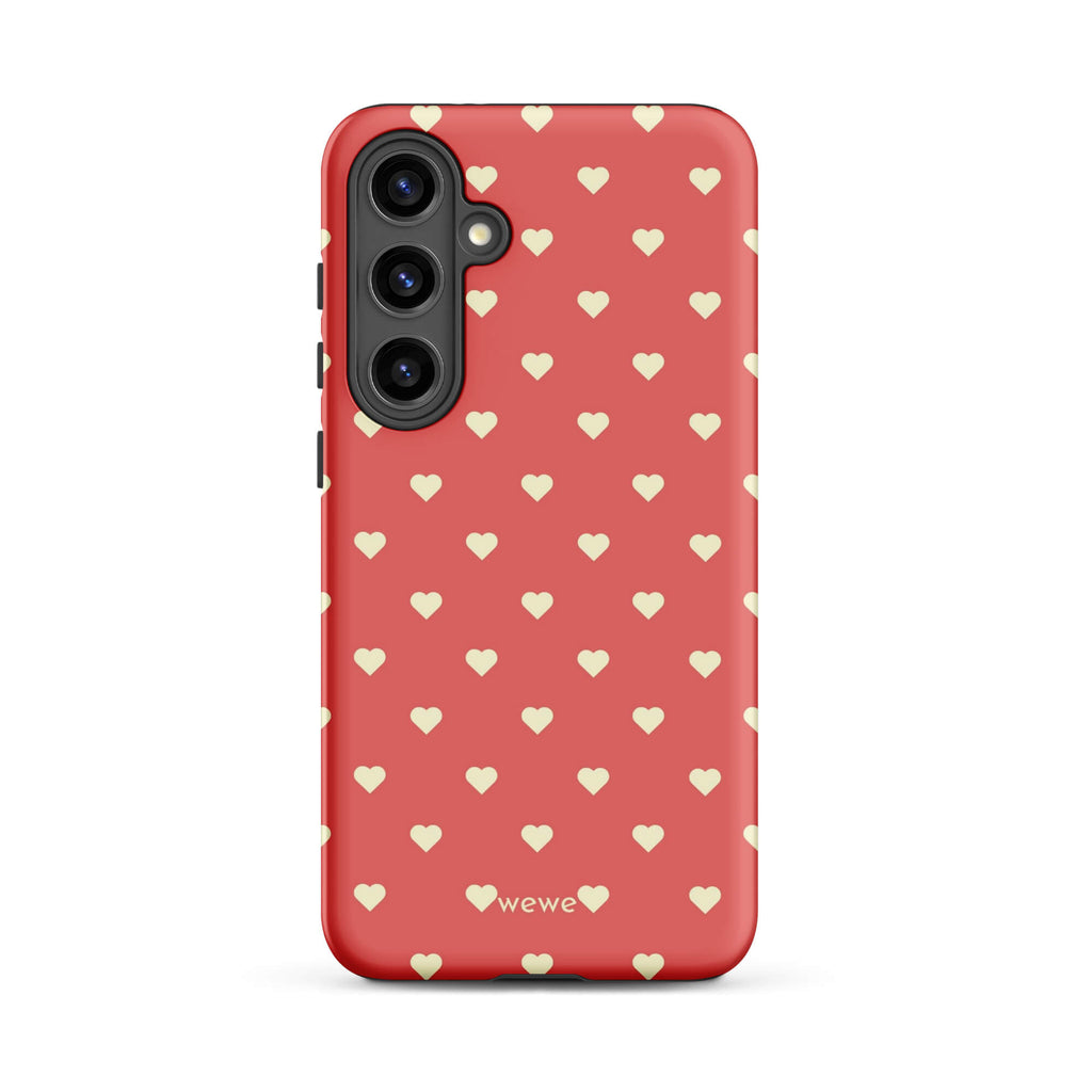 Coral-pink iPhone case with evenly spaced soft-cream mini hearts