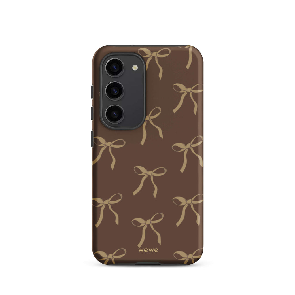 Custom samsung galaxy s23 tough case in matte dark espresso brown featuring an all-over repeating pattern of light taupe/tan ribbons/bows, with 'wewe' branding at the bottom.