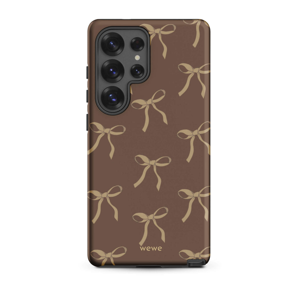 Custom samsung galaxy s25 ultra tough case in matte dark espresso brown featuring an all-over repeating pattern of light taupe/tan ribbons/bows, with 'wewe' branding at the bottom.