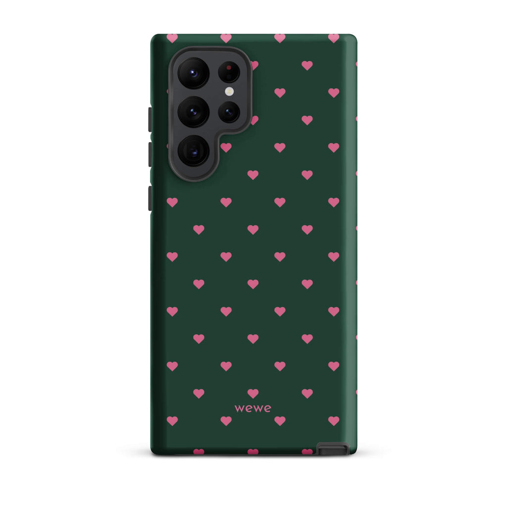 Deep forest-green iPhone case with evenly spaced vivid-pink mini hearts