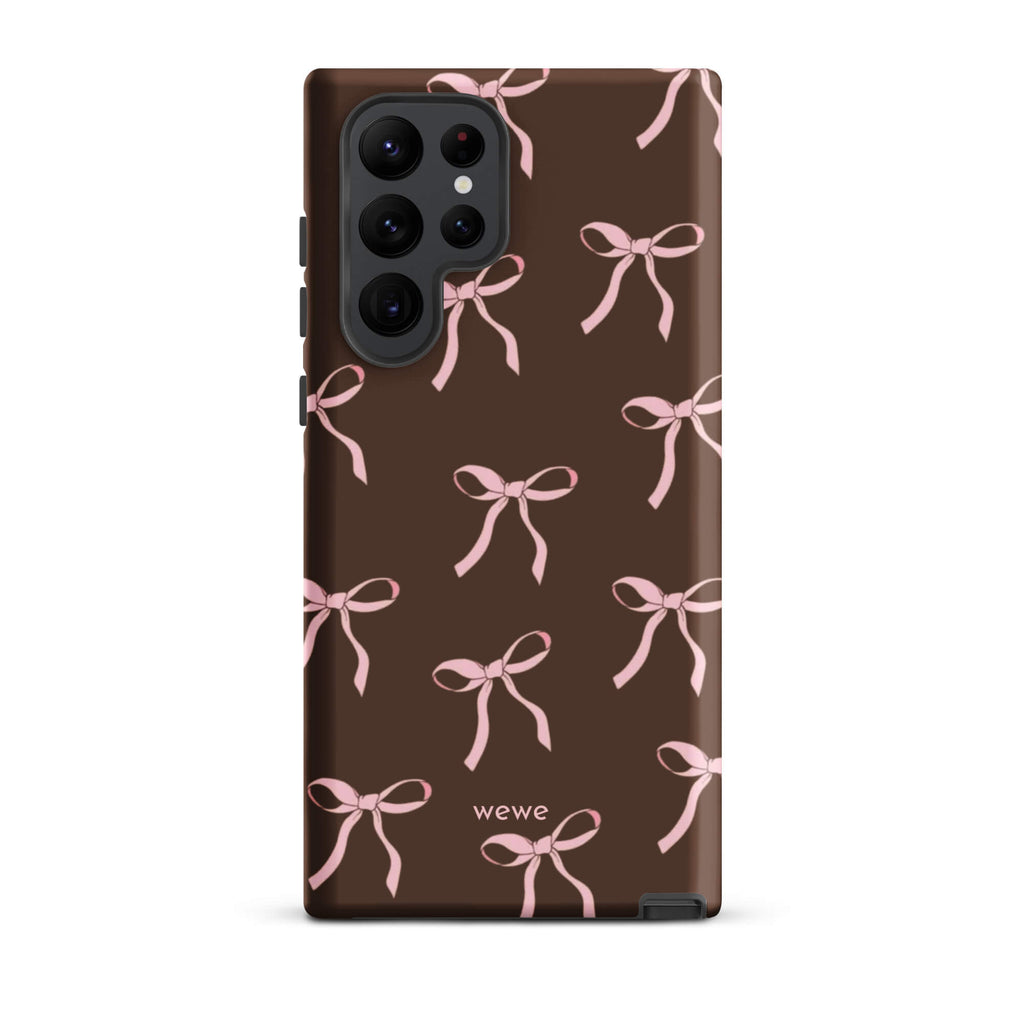 Custom samsung galaxy s22 ultra tough case in matte dark brown (chocolate) featuring an all-over repeating pattern of light pink ribbons/bows, with 'wewe' branding at the bottom.