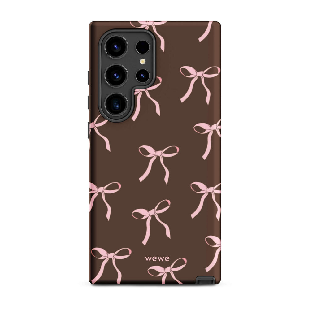 Custom samsung galaxy s24 ultra tough case in matte dark brown (chocolate) featuring an all-over repeating pattern of light pink ribbons/bows, with 'wewe' branding at the bottom.