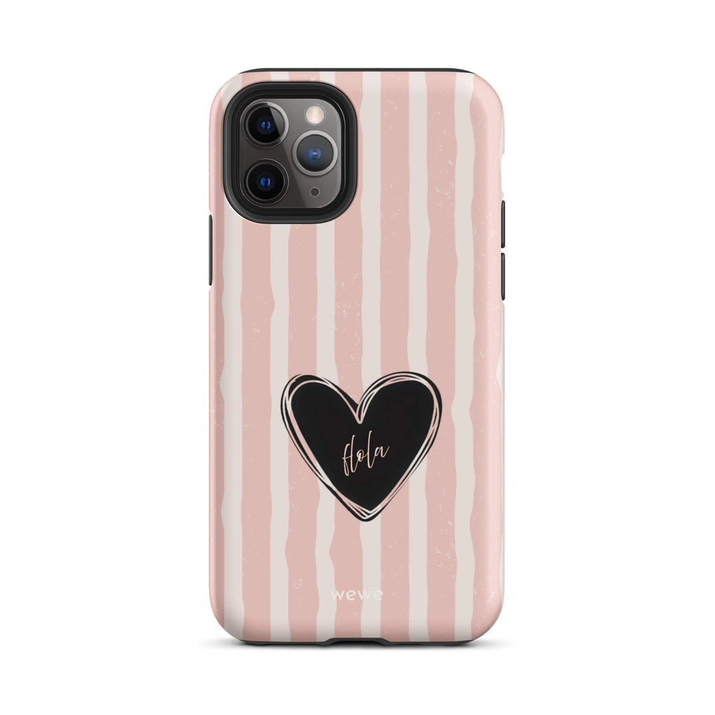 Custom iPhone case 11 pro featuring a matte distressed pattern of pale pink and white vertical stripes, centered with a black heart graphic containing the word 'Hola' in cursive, and 'wewe' branding at the bottom.