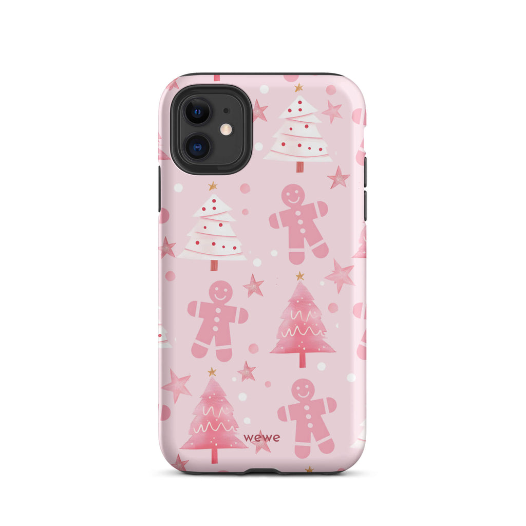 Custom iPhone 11 tough case featuring a soft pastel pink background with a scattered pattern of pink gingerbread men, pink and white Christmas trees, and watercolor pink stars, with 'wewe' branding at the bottom.