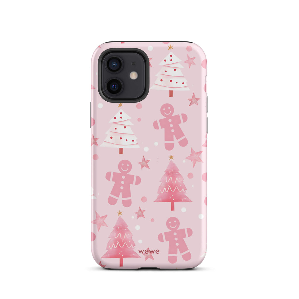 Custom iPhone 12 tough case featuring a soft pastel pink background with a scattered pattern of pink gingerbread men, pink and white Christmas trees, and watercolor pink stars, with 'wewe' branding at the bottom.