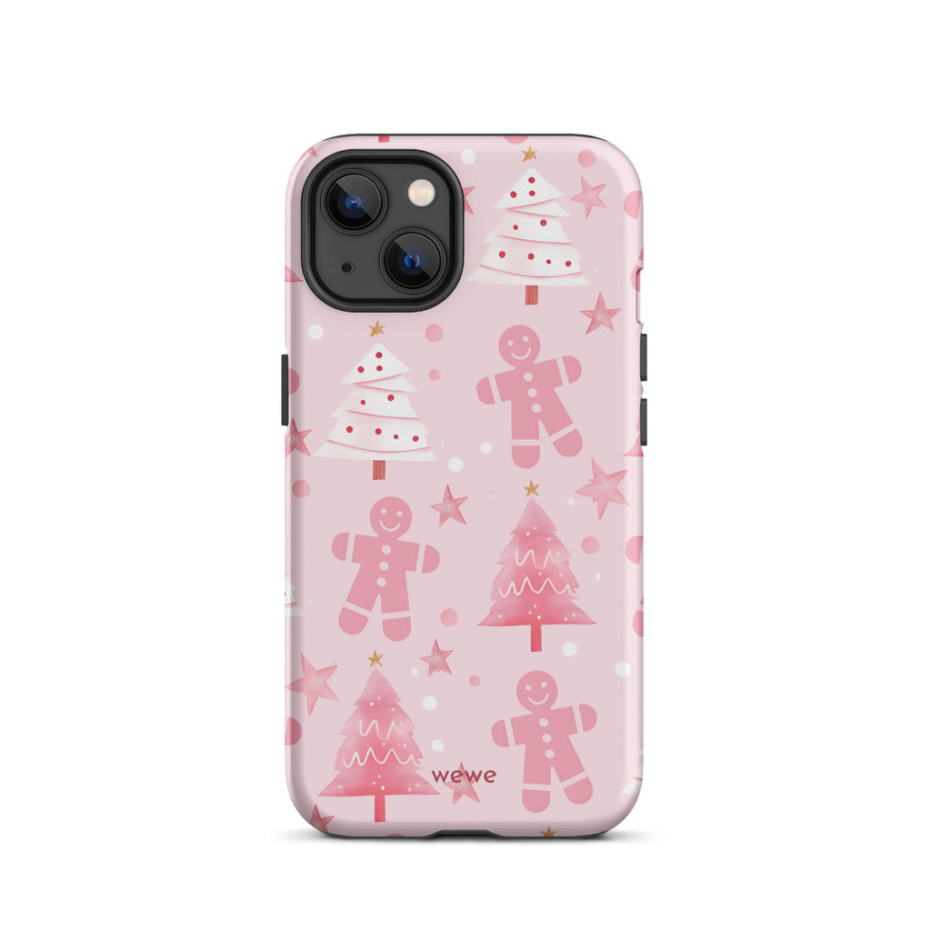 Custom iPhone 13 tough case featuring a soft pastel pink background with a scattered pattern of pink gingerbread men, pink and white Christmas trees, and watercolor pink stars, with 'wewe' branding at the bottom.