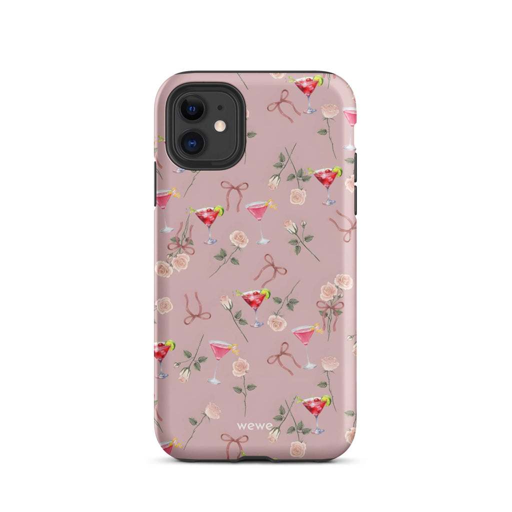 Custom iPhone case 11 with a repeating pattern of pink roses, ribbon bows, and red cocktail glasses on a light rose colour background.