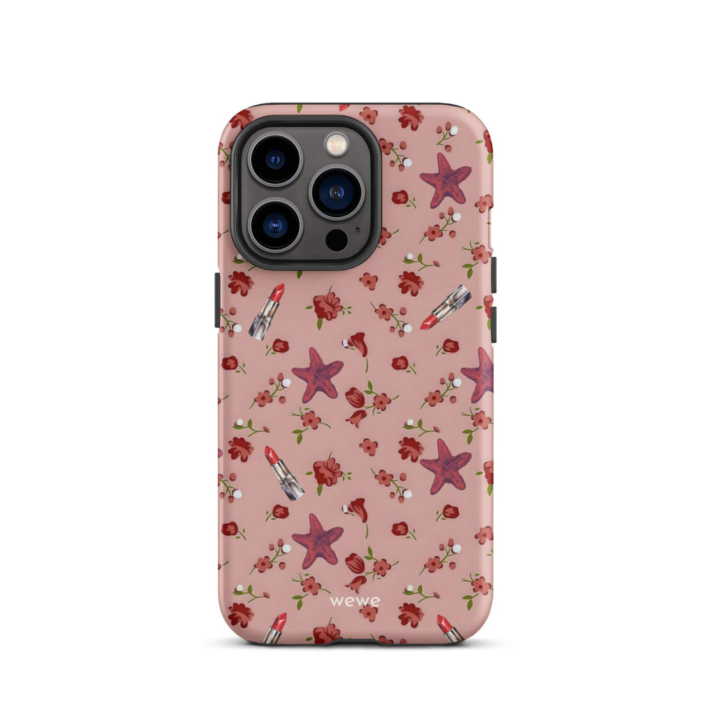 Custom iPhone case 13 pro with a  retro pattern of red flowers, starfish, and lipstick tubes on a pink rose colour background.