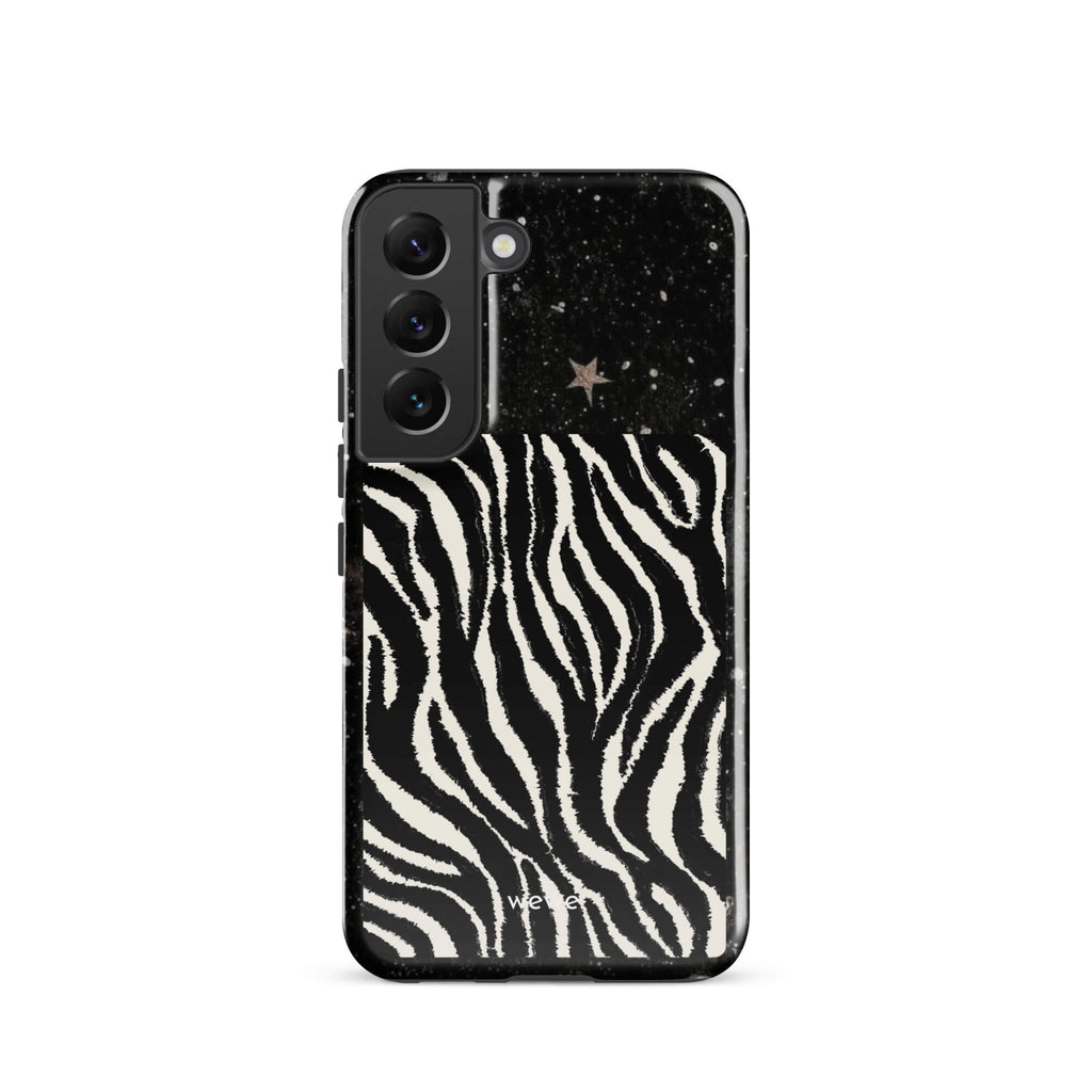 Custom samsung galaxy s22 with a black, glittery cosmic/galaxy top half with stars, and a bold black and white zebra stripe pattern on the bottom half.
