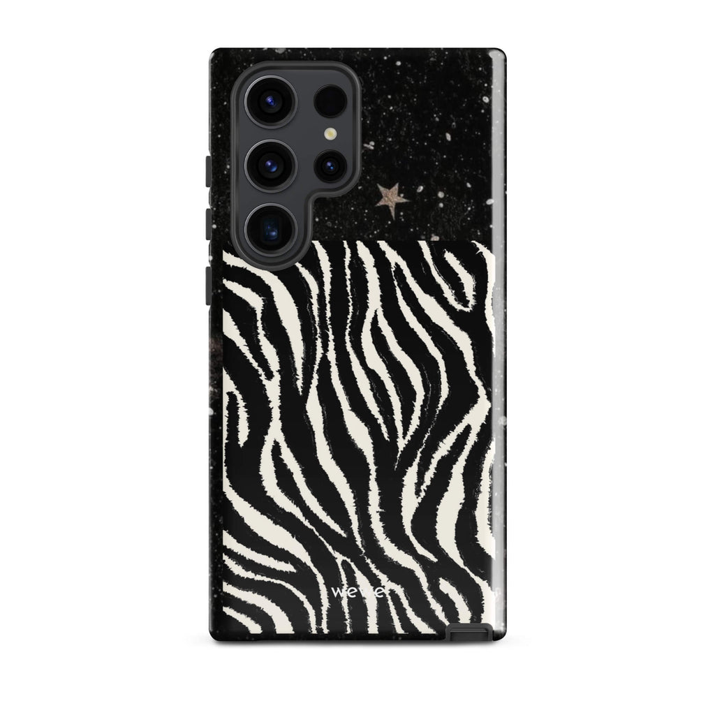 Custom samsung galaxy s23 ultra with a black, glittery cosmic/galaxy top half with stars, and a bold black and white zebra stripe pattern on the bottom half.