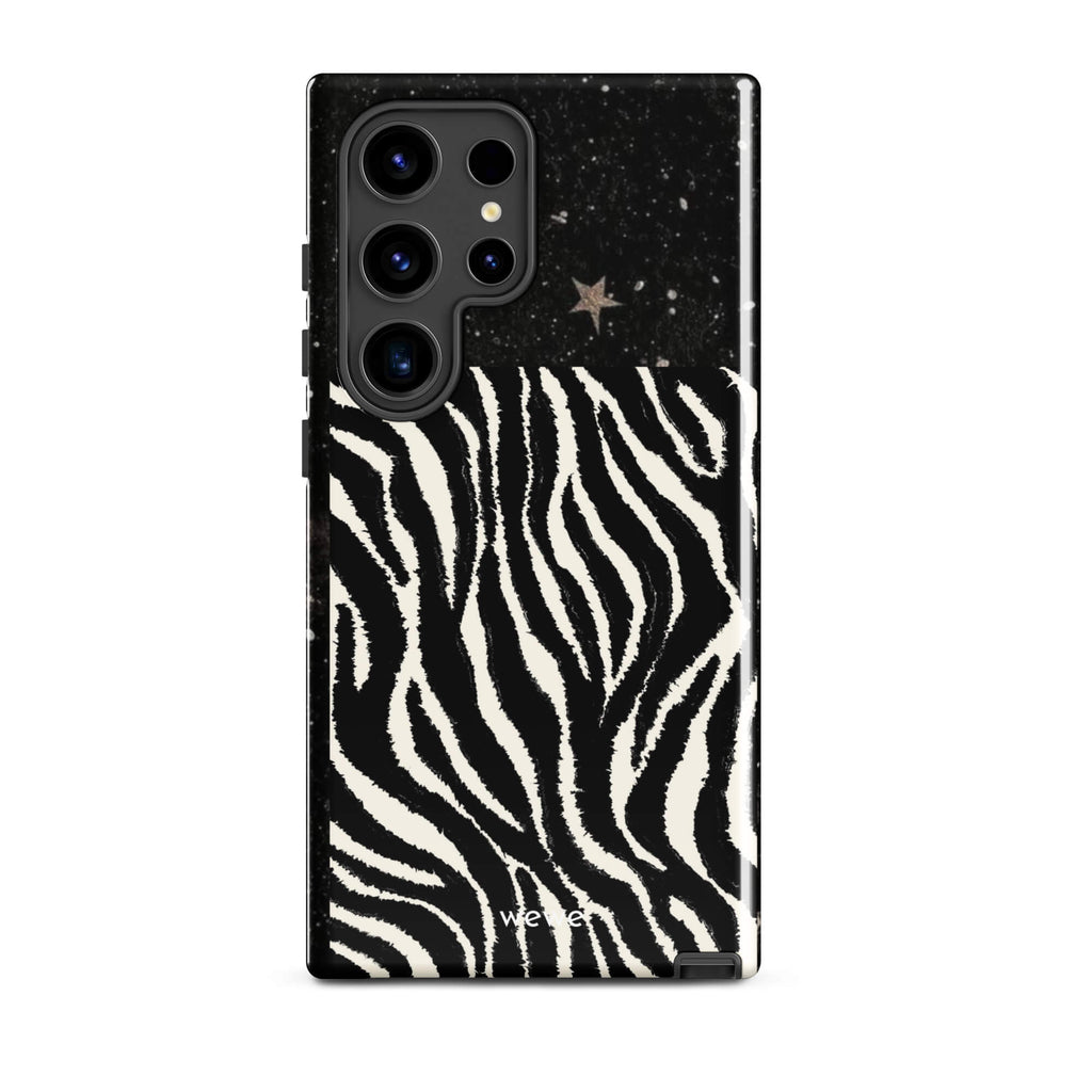 Custom samsung galaxy s24 ultra with a black, glittery cosmic/galaxy top half with stars, and a bold black and white zebra stripe pattern on the bottom half.