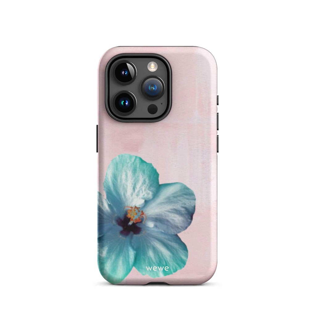 Custom iPhone case 15 pro with a photo of a blue hibiscus flower with a green center on a soft pink painted 