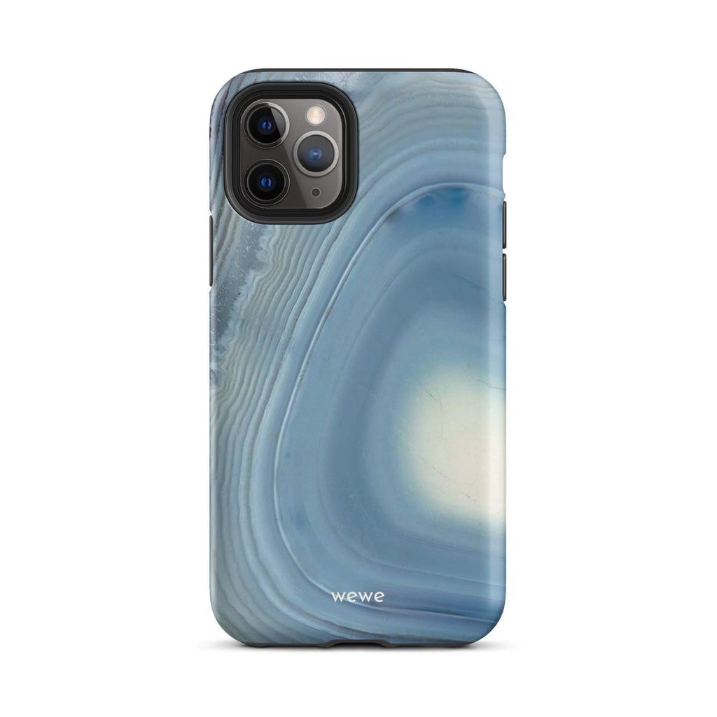 Custom iPhone case 11 pro with a  close-up image of a blue and white geode or agate slice with swirling patterns.