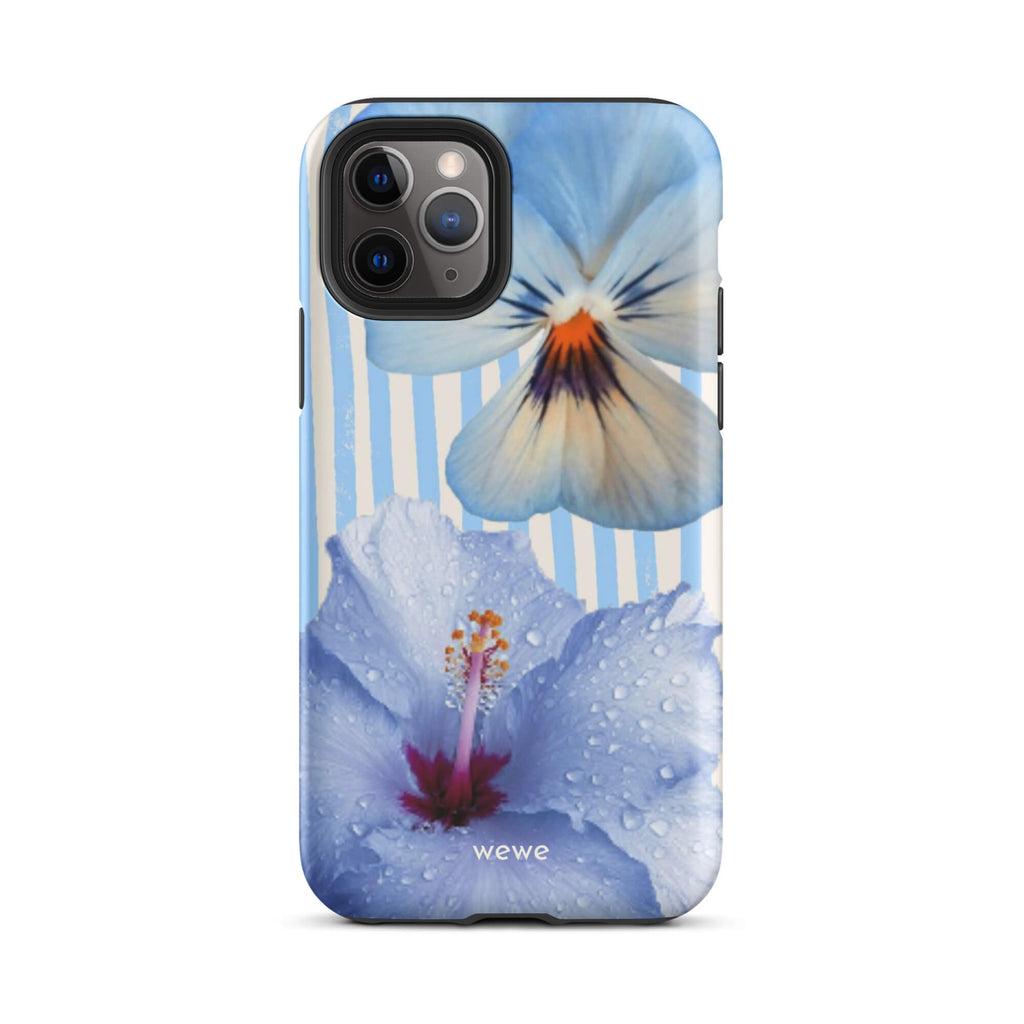 Custom iPhone case 11 pro with a photo of a blue hibiscus flower with water droplets and a white pansy on a striped background.
