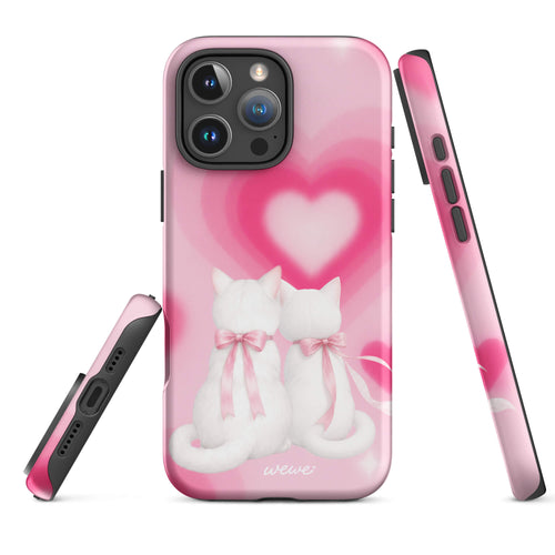 Blush-pink iPhone case with two white cats, pink bows and a layered soft-focus heart