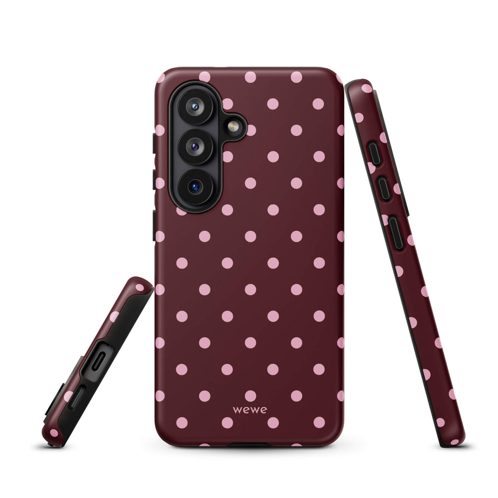 Deep burgundy iPhone case with evenly spaced soft-pink polka dots