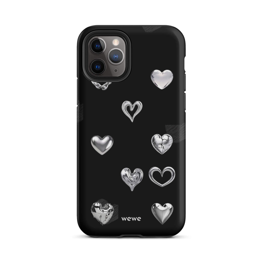 Custom iPhone case 11 pro with a black background and shiny silver chrome heart charms in various designs, including a cracked heart.