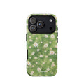 Green painterly meadow phone case covered with scattered white daisies and soft yellow flower centers