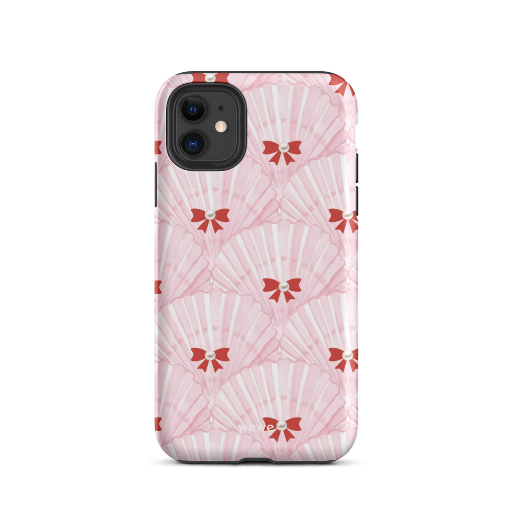 Custom iPhone case 11 with a cute and whimsical pattern of watercolor pink and white seashells with red bows and pearls.