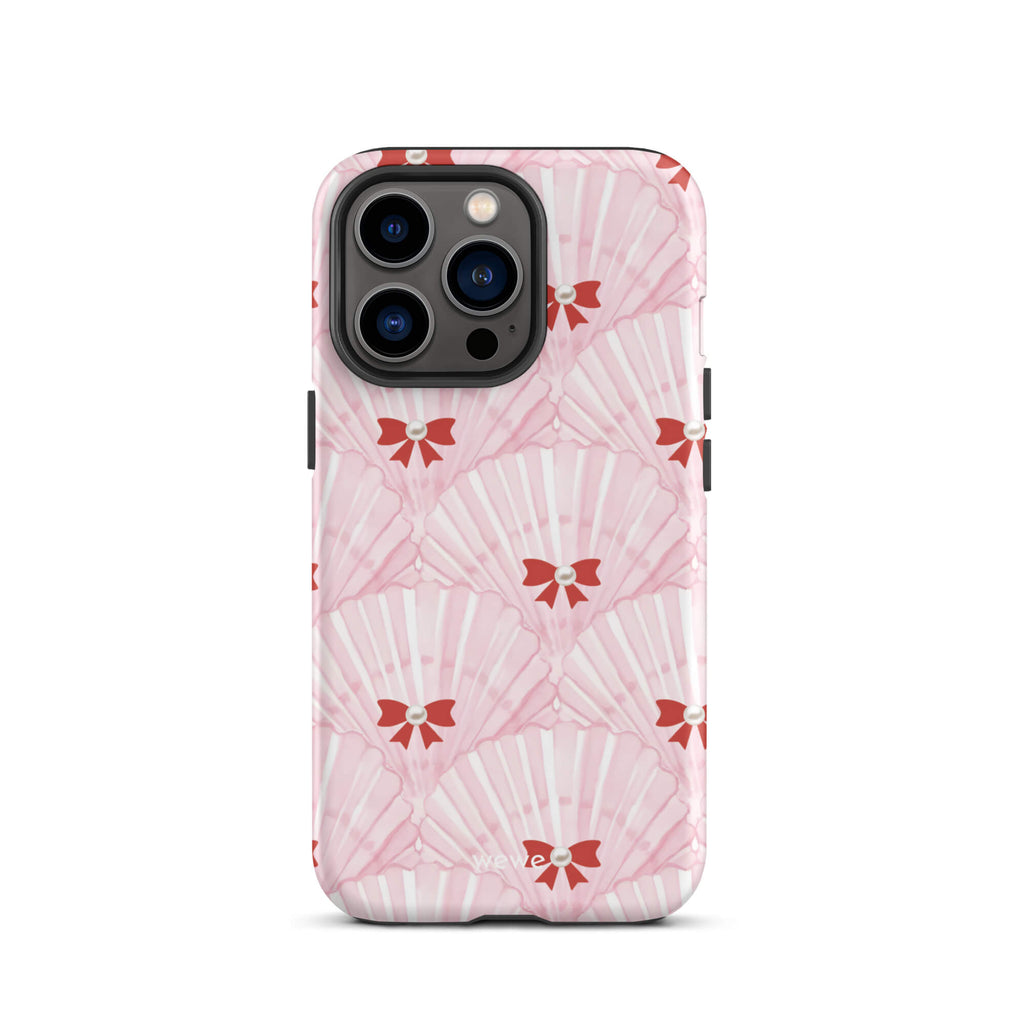Custom iPhone case 13 pro with a cute and whimsical pattern of watercolor pink and white seashells with red bows and pearls.