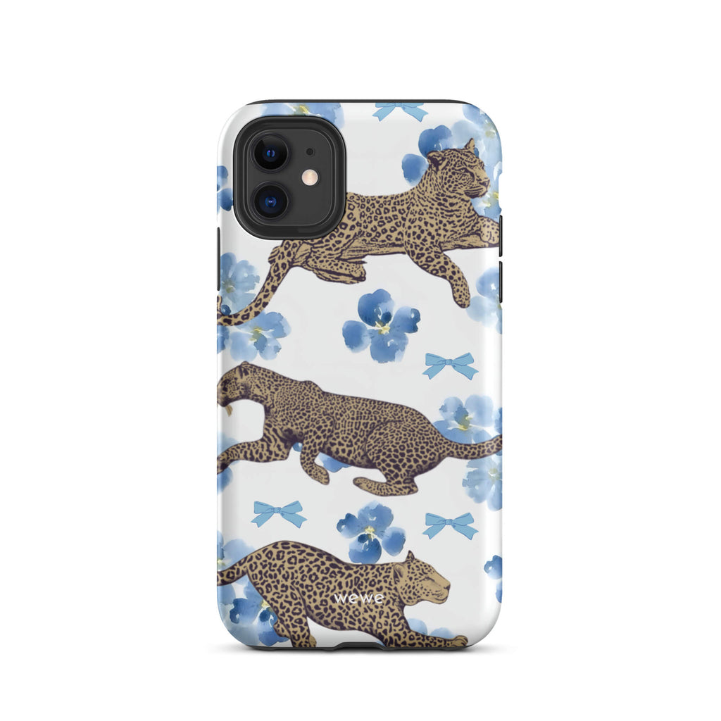Custom iPhone case 11 with a cute pattern of leopard print cheetahs, blue pansies, and small ribbons on a white background.