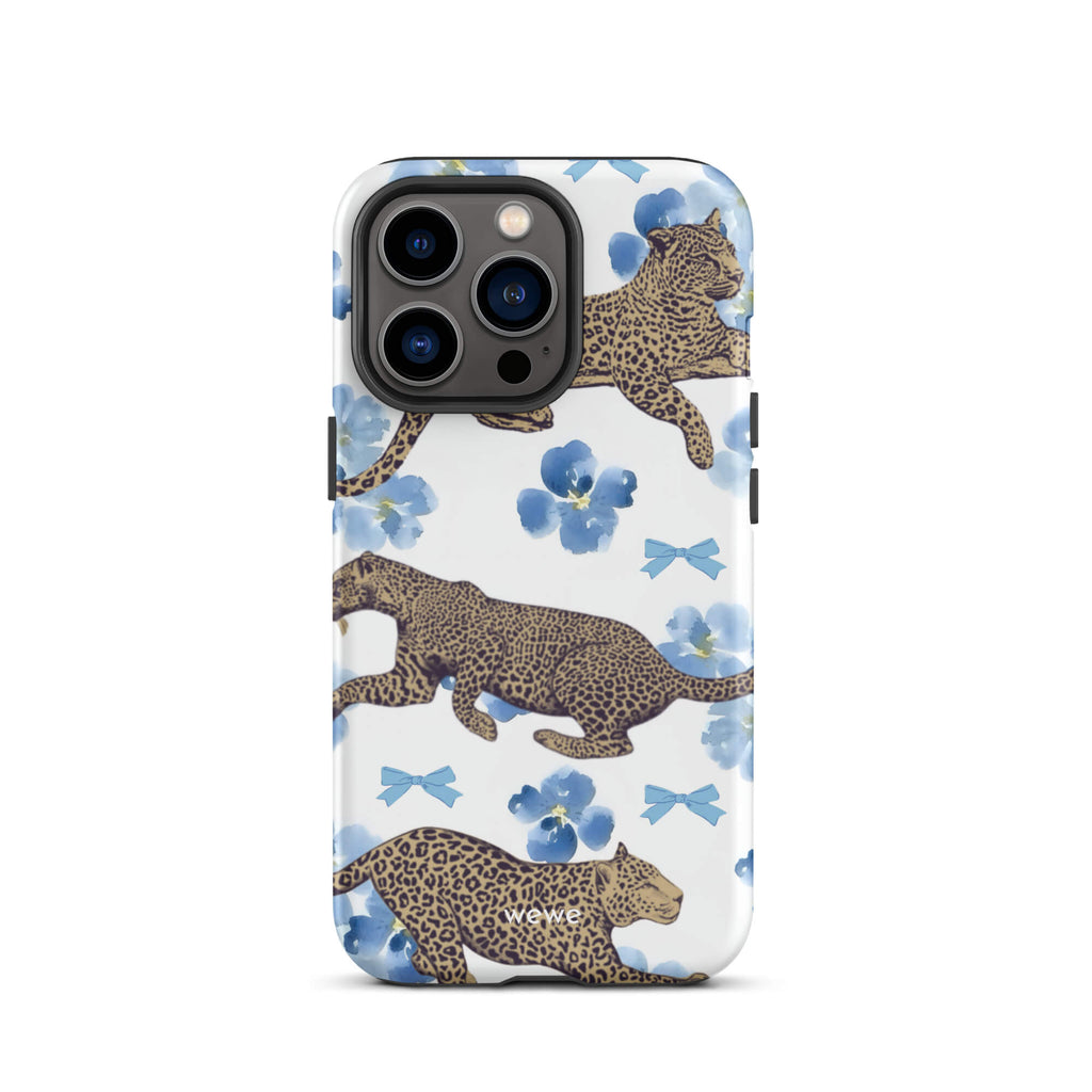 Custom iPhone case 13 pro with a cute pattern of leopard print cheetahs, blue pansies, and small ribbons on a white background.