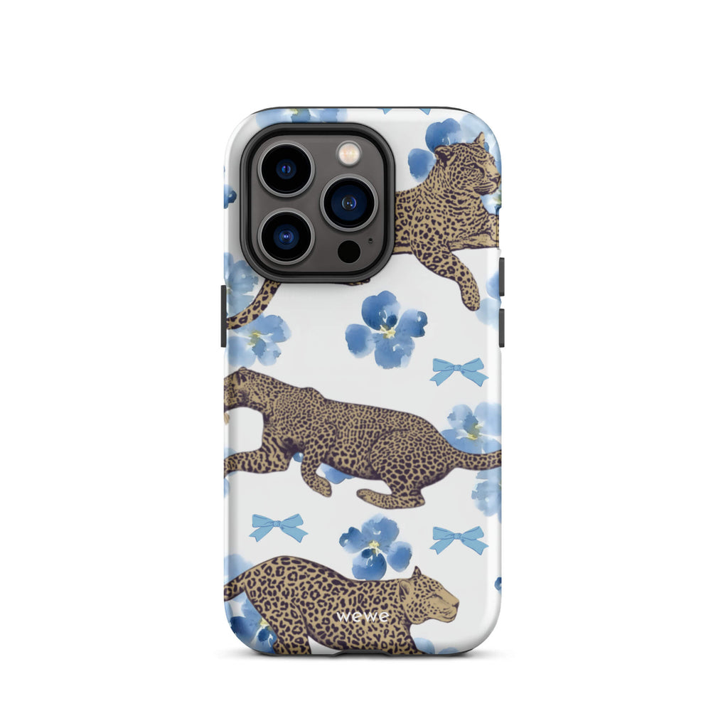 Custom iPhone case 14 pro with a cute pattern of leopard print cheetahs, blue pansies, and small ribbons on a white background.