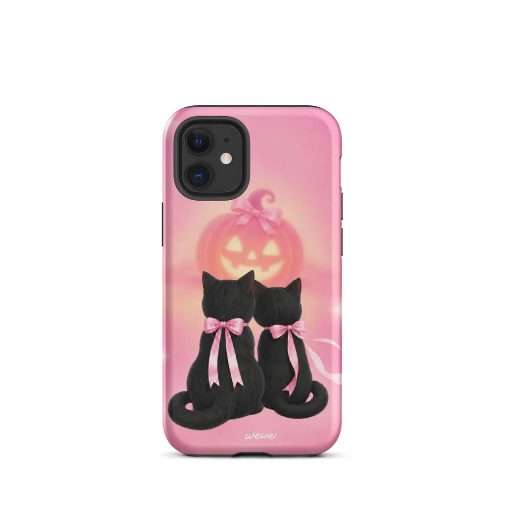 Bubblegum-pink iPhone case with two black cats wearing pink bows and a glowing jack-o-lantern
