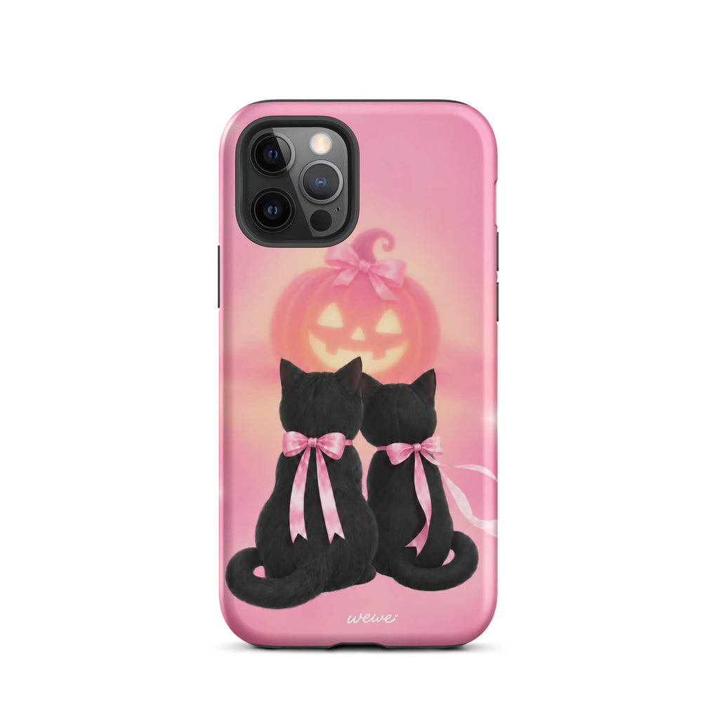 Bubblegum-pink iPhone case with two black cats wearing pink bows and a glowing jack-o-lantern