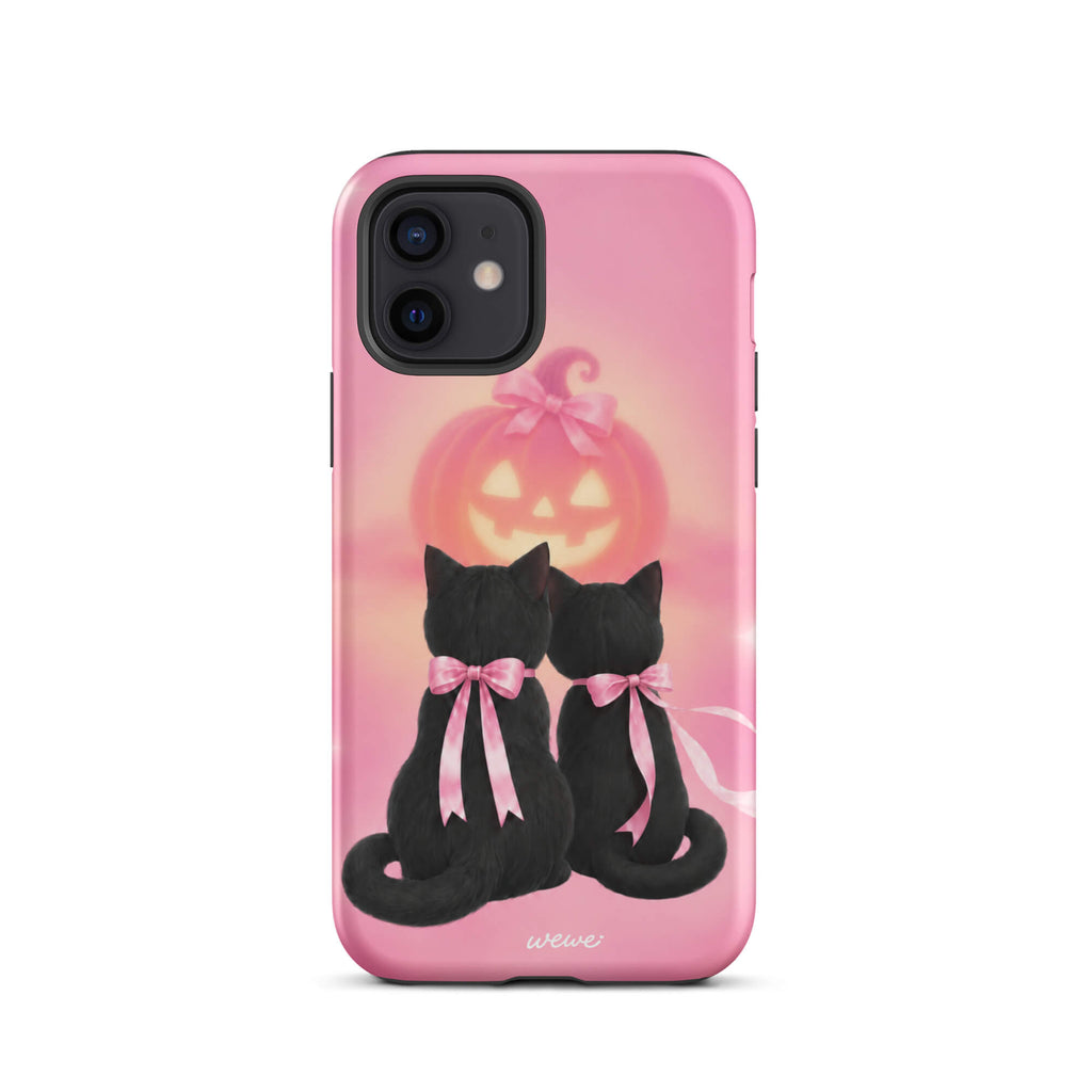Bubblegum-pink iPhone case with two black cats wearing pink bows and a glowing jack-o-lantern