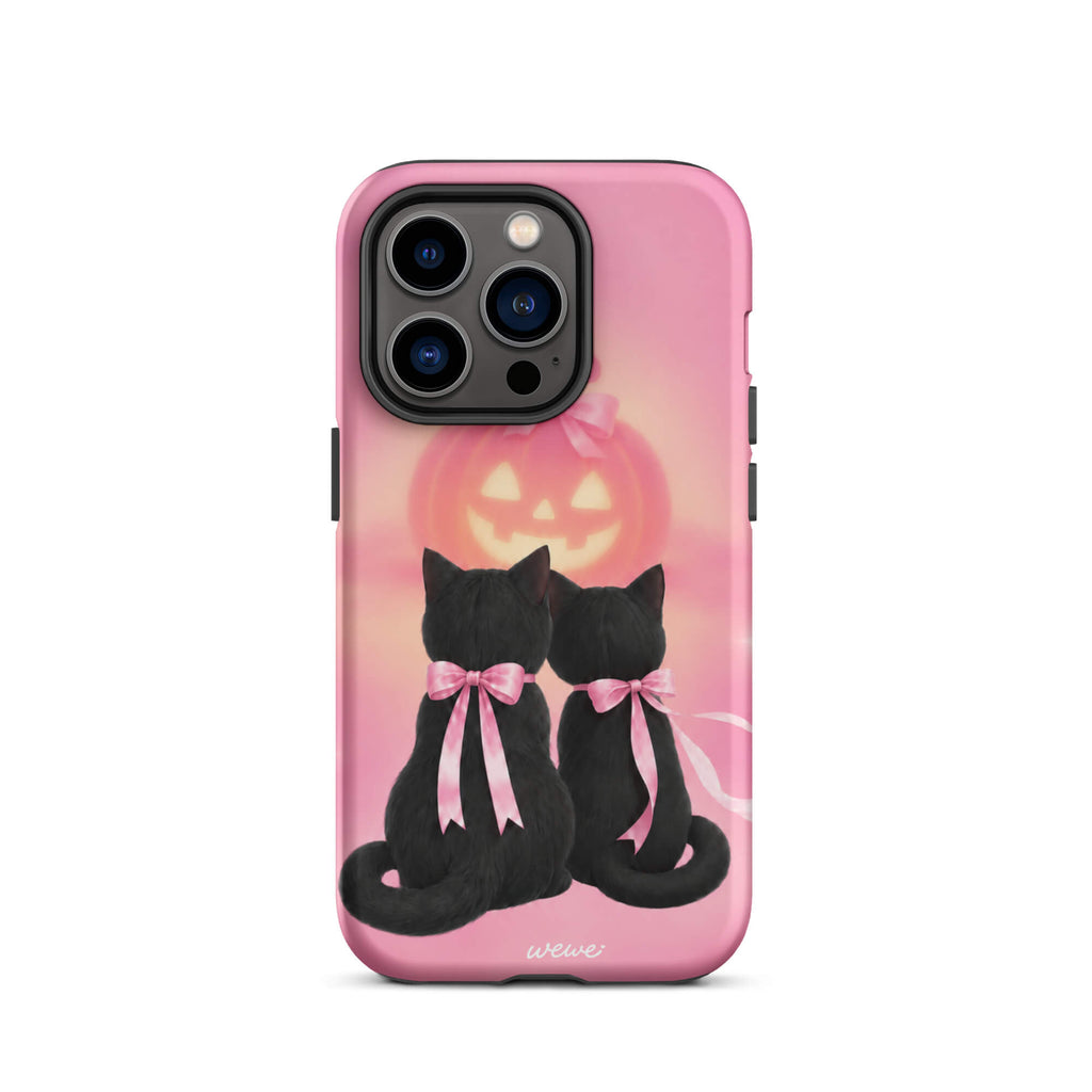 Bubblegum-pink iPhone case with two black cats wearing pink bows and a glowing jack-o-lantern
