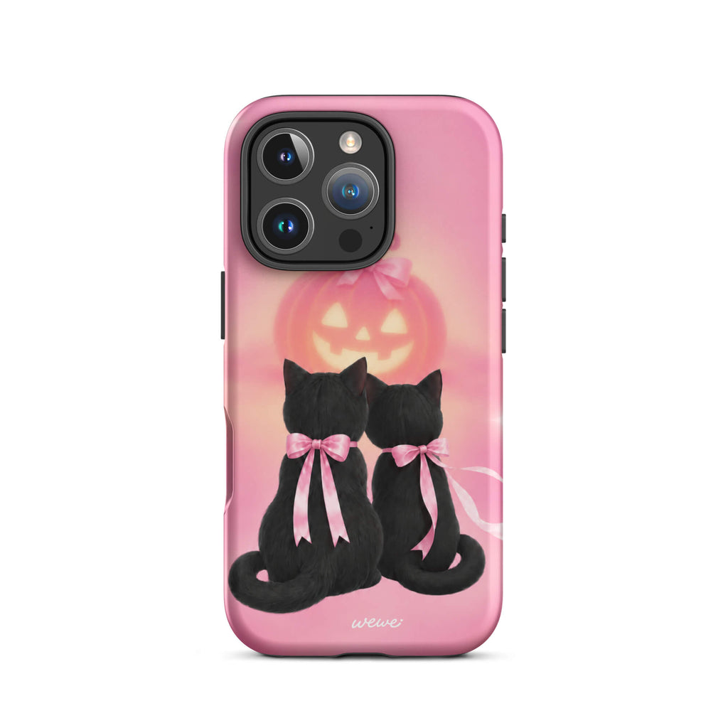 Bubblegum-pink iPhone case with two black cats wearing pink bows and a glowing jack-o-lantern