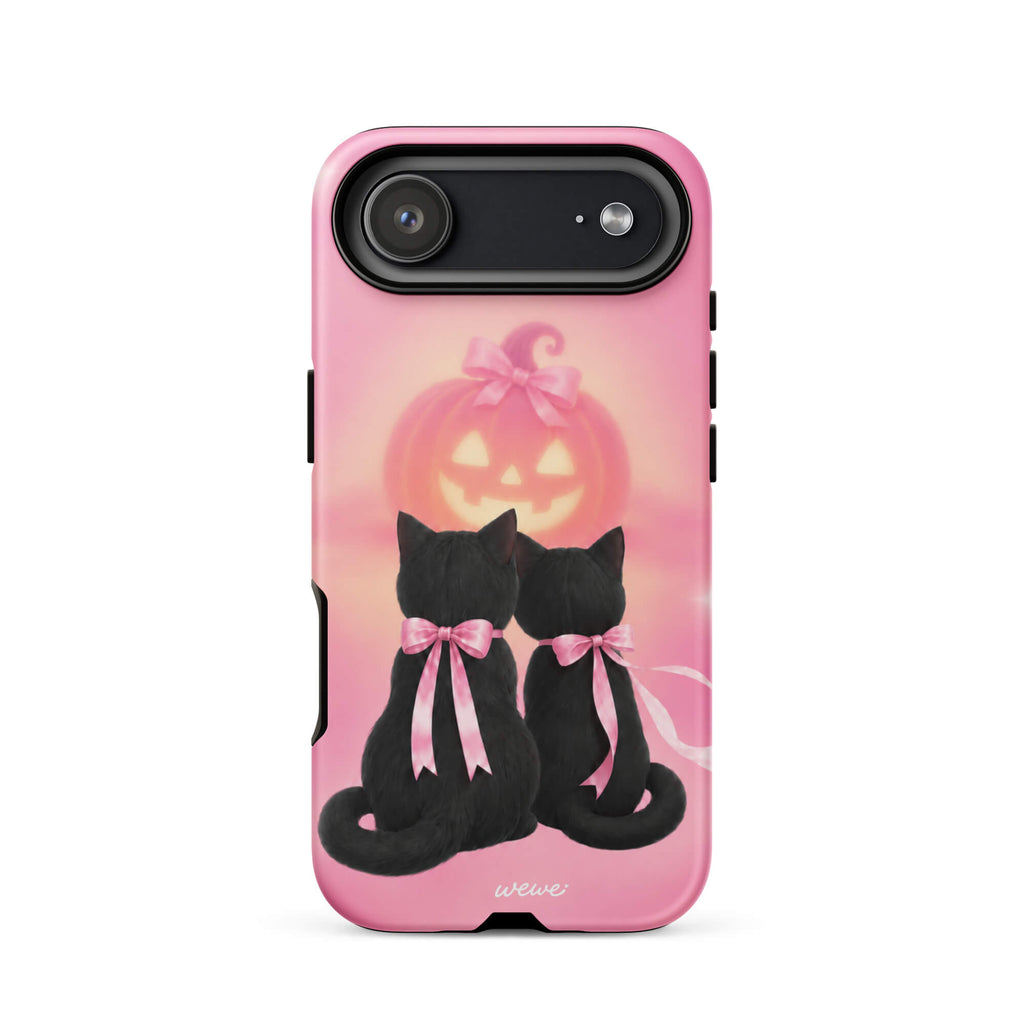 Bubblegum-pink iPhone case with two black cats wearing pink bows and a glowing jack-o-lantern