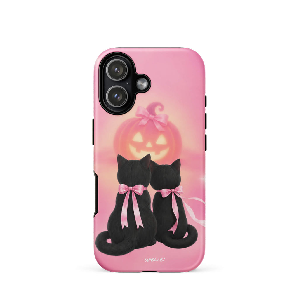 Bubblegum-pink iPhone case with two black cats wearing pink bows and a glowing jack-o-lantern